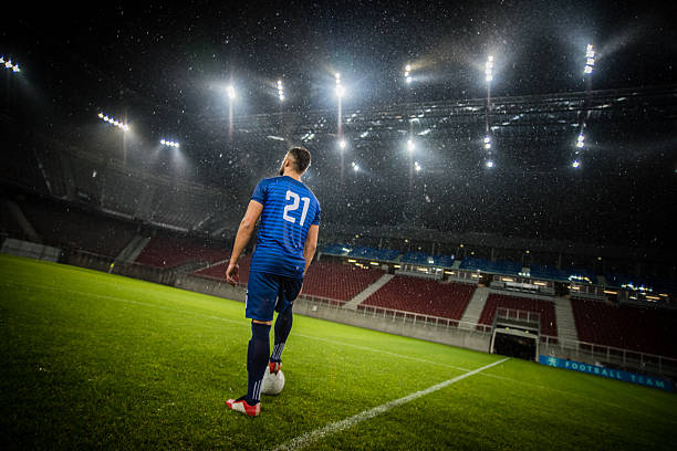 istock Football player standing in stadium 637137706