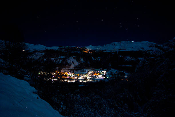 istock Lighting village in mountains at night, snow, New Year 637138376