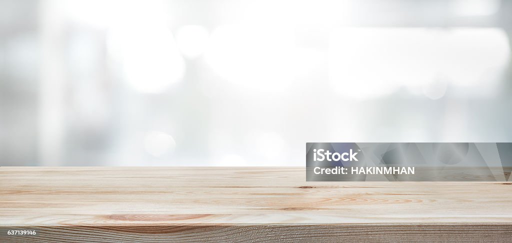 Wood table top on blur glass window wall background. Wood table top on blur glass window wall building background.For montage product display or design key visual layout background. Backgrounds Stock Photo