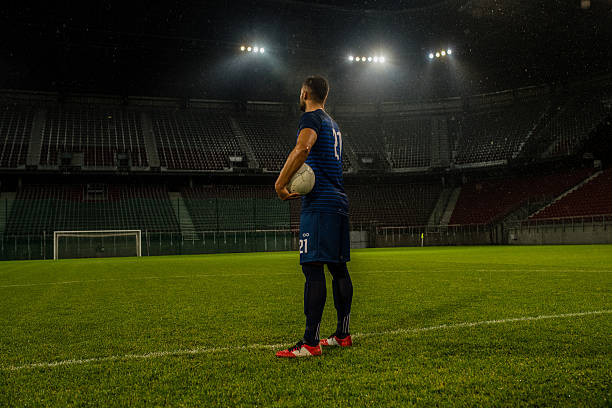 Football player standing in stadium