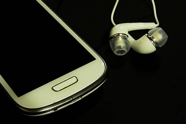 istock Smartphone with earphones  on black background 637140924