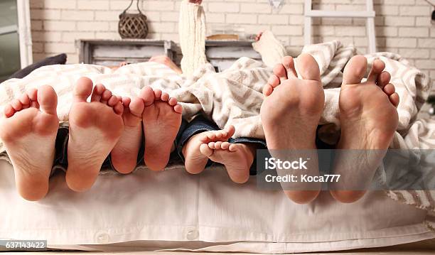 Feet Happy Family Stock Photo - Download Image Now - Family, Bed - Furniture, Sleeping