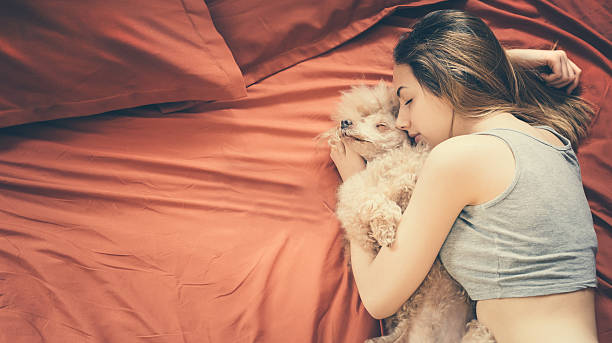 istock Girl lying and sleeping with dog in bed. 637143526