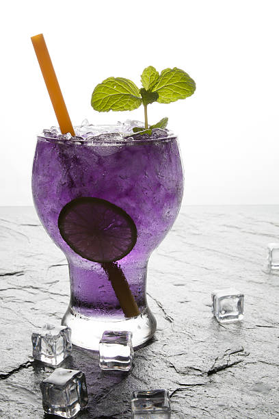 istock Purple soda lime drink with lime on stone. 637149464