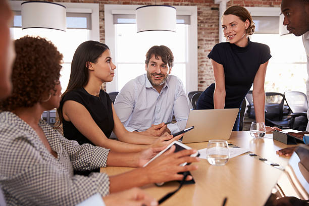 istock Businesspeople Meeting Around Table In Modern Office 637151456