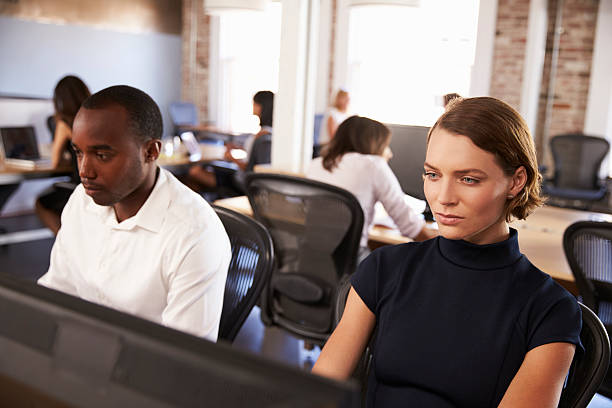 istock Businesspeople Working At Computers In Busy Modern Office 637151506