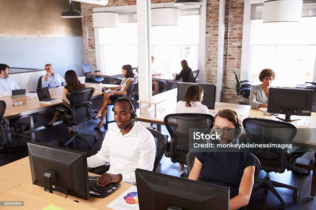 View Of Staff In Busy Customer Service Department Call Center Stock Photo