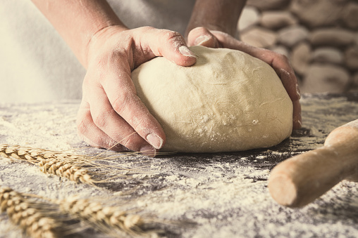 hands crumple dough