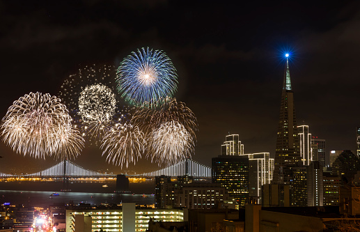 Firework at San Francisco downtown New Year. Bay bridge and downtown on the background.