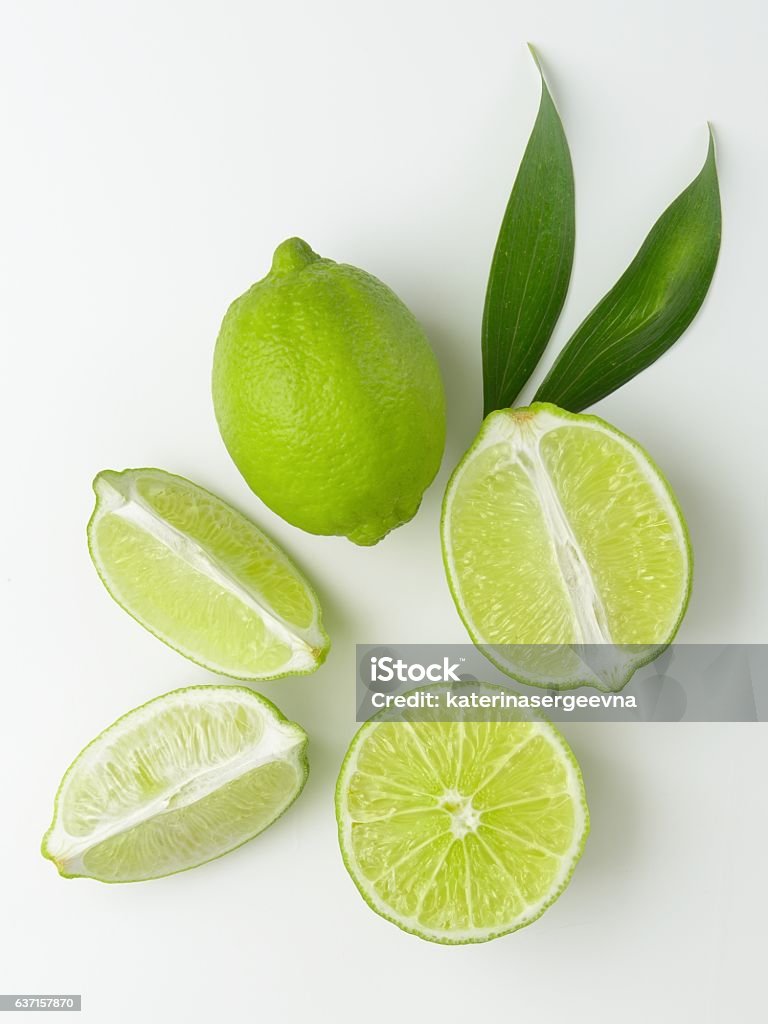 lime some fresh limes with leaves on a white background Lime Stock Photo