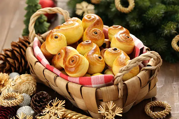 Photo of homemade swedish saffron buns, lussekatt in basket