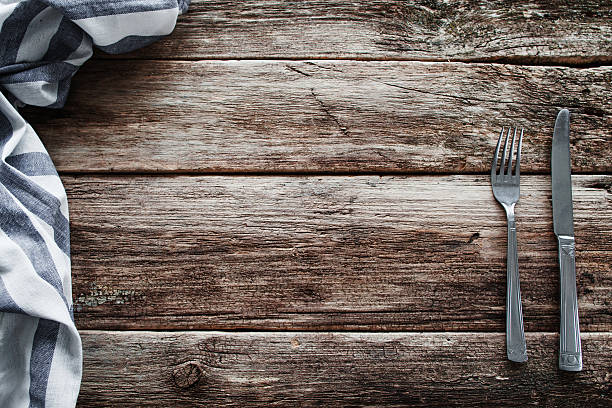 istock Cutlery and napkin frame on old wooden table 637161308