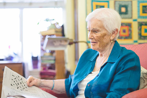 istock A senior citizen is relaxing in her home and reading 637163192