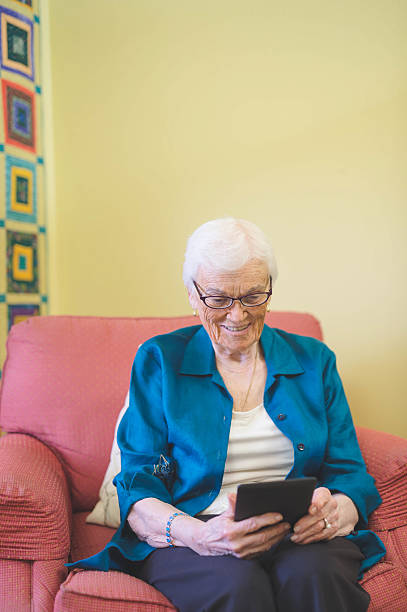 istock A senior citizen is relaxing in her home and reading 637163222