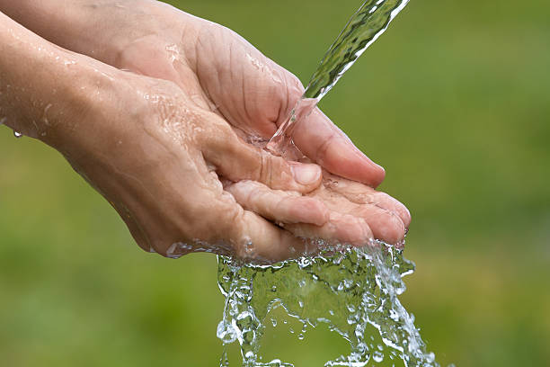 istock washing of hands on nature background 637163580