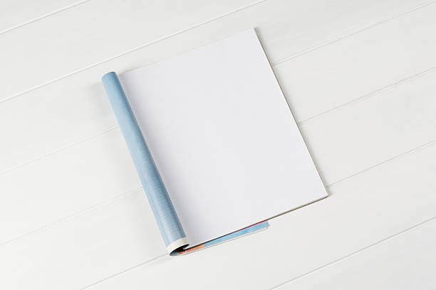 Mock-up magazines or catalog on wooden table background.