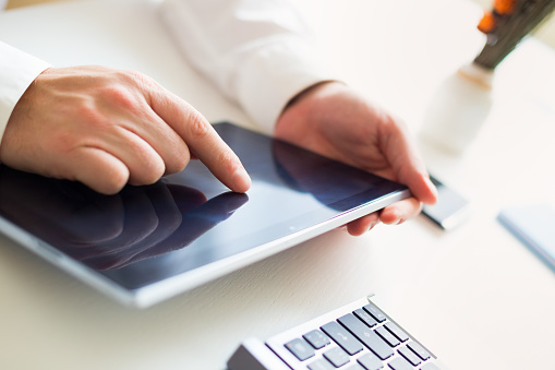 Tablet Computer Using Using A Computer Tablet Stock Photo - Download Image Now - Adult, Black ...