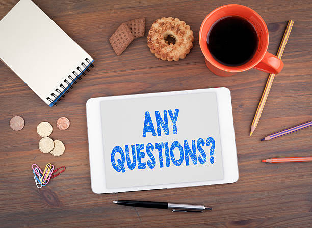 istock Any Questions. Text on tablet device on a wooden table 637169920