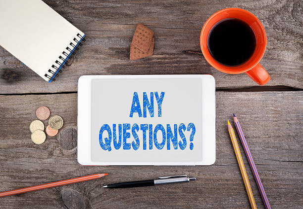 istock Any Questions. Text on tablet device on a wooden table 637169922