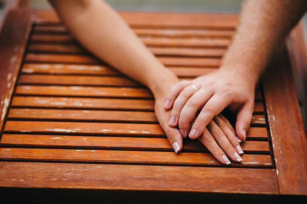 istock lovely couple holding hands together 637170282