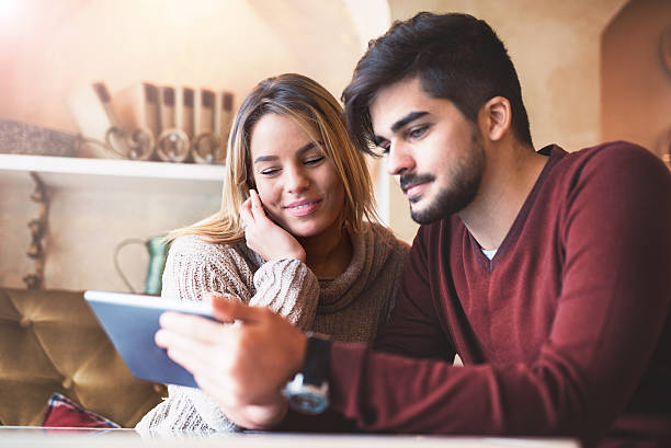 istock Loving couple sitting in the cafe and having fun with 637171428