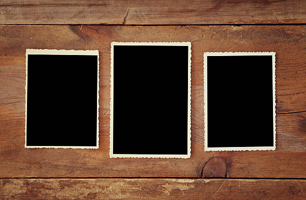 istock blank photo frames on wooden background 637171848