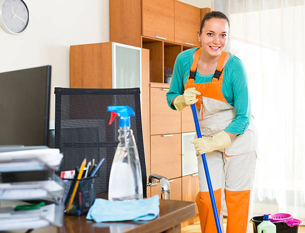 istock Woman cleaning office room 637175616