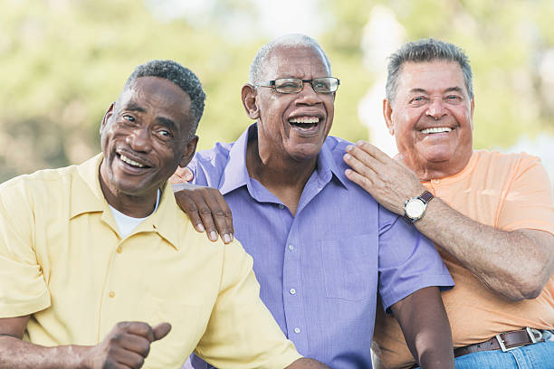 istock Multi-ethnic senior men on park bench, smiling 637178474
