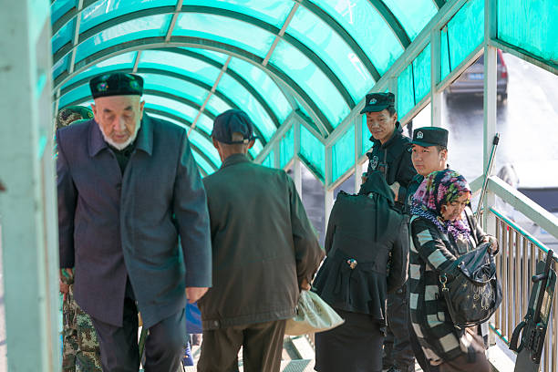 military patrol at bus station, urumqi,xinjiang, china - urumqi stockfoto's en -beelden