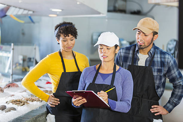 istock Team of workers in seafood market 637178578