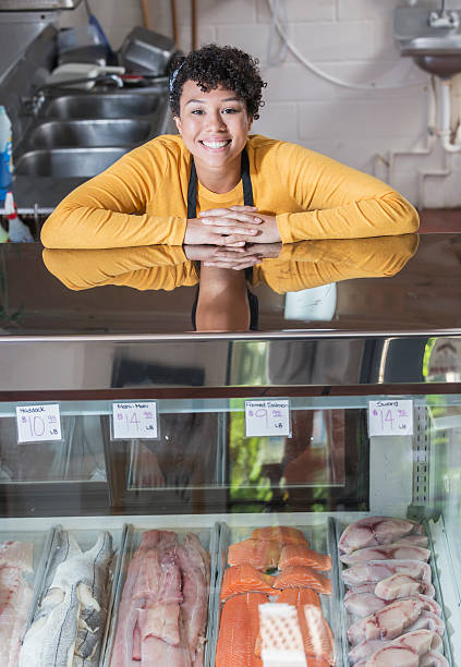 istock Mixed race woman working in fish market 637179156