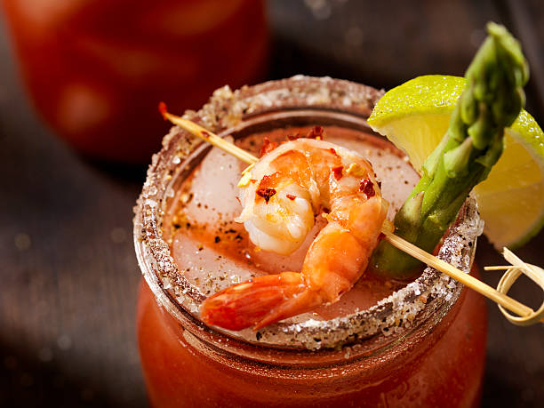 Shrimp Bloody Mary or Caesar Cocktail Bloody Mary or Caesar Cocktail on the Rocks with Lime, Celery and a Spiced Rim-Photographed on Hasselblad H3D2-39mb Camera bloody mary stock pictures, royalty-free photos & images