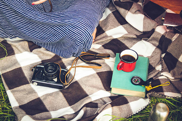 istock coffee cup and books in the green grass in summer 637180176