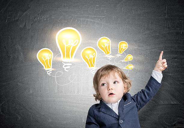 istock Baby boy and light bulbs on chalkboard 637180376