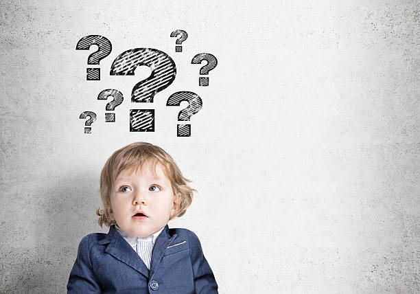 istock Baby boy and question marks on concrete wall 637181758