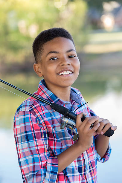 istock Confident young boy with fishing pole 637182336