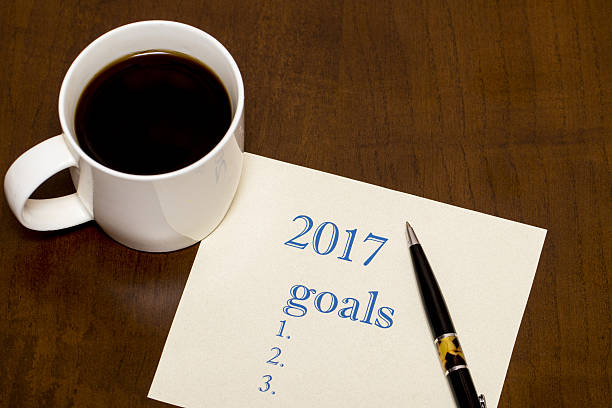 istock 2017 list of goals on paper, a wooden table with 637182986