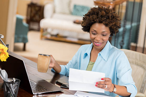 istock Self employed woman reads her mail in home office 637183234