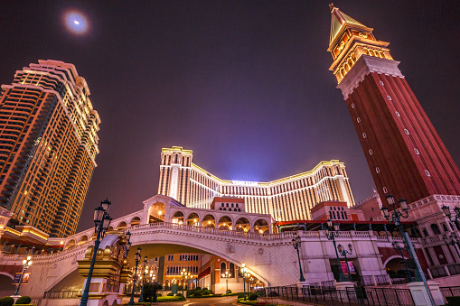 Macau, China - December 8, 2016: Cotai Strip at night: tower, bridge, shopping center, The Venetian and Four Seasons Hotel. Cotai Strip is a duty-free shopping paradise with almost 600 retail outlets.