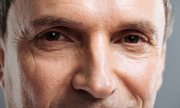 istock Close up of happy doctors face smiling on grey background 637184642