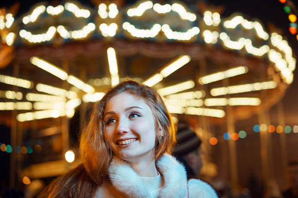 istock red-haired girl on carousel in winter 637185060