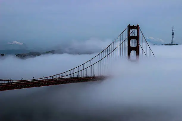 View of the Golden Gate Bridge and Sutro Tower through the fog.