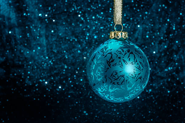 Decorative Christmas tree ball in front of sparkling background stock photo