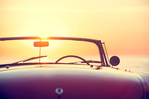 istock Rear view of a convertible car at sunset 637186424