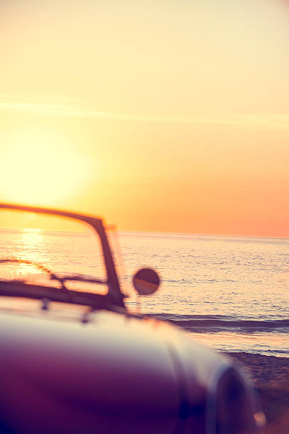 istock Rear view of a convertible car at sunset 637186478