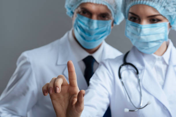 istock Delighted colleagues using medical glass 637186556