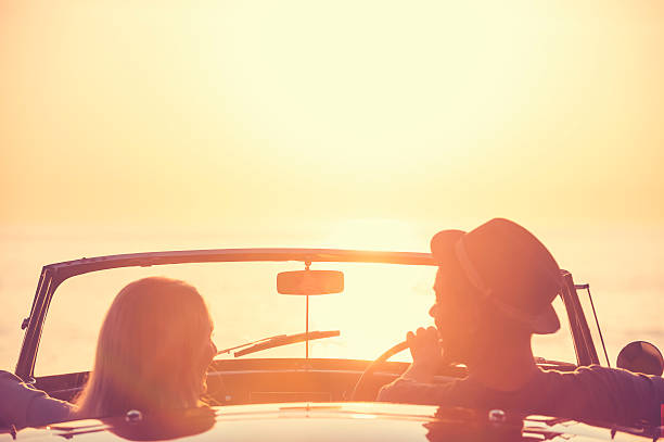 istock Couple watching the sunset in a convertible car 637186614