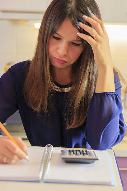 istock Close up of businesswoman hands using calculator 637186910