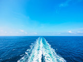 Ocean wake from cruise ship, on bright summer day.