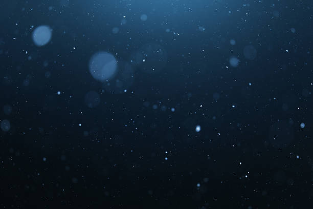 Snowing blue background bokeh light stock photo